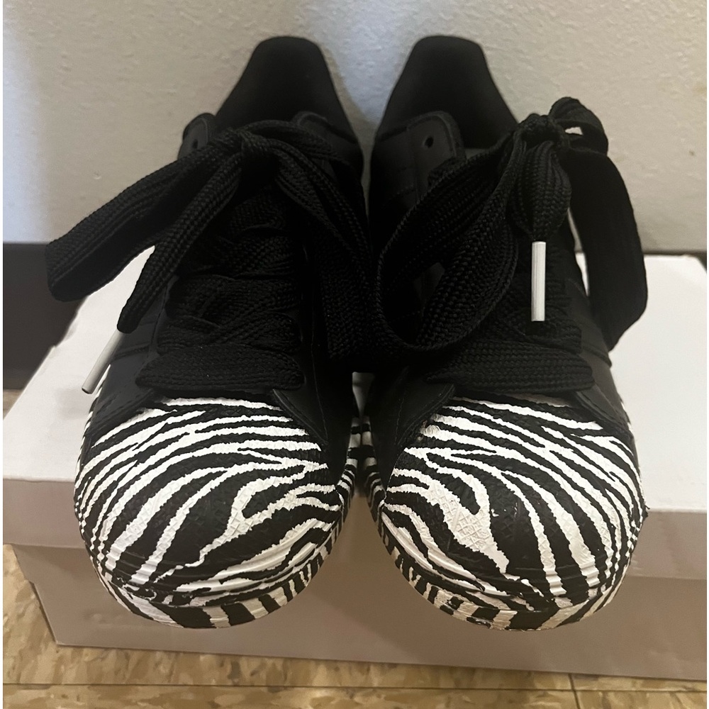 Black adidas superstar (shelltoes) with zebra print.